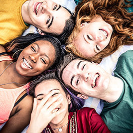 Group of  friends laughing out loud outdoor, sharing good and positive mood.