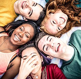 Group of friends laughing out loud outdoor, sharing good and po Group of friends laughing out loud outdoor, sharing good and positive mood.