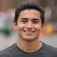 Young latino man in city face portrait smile